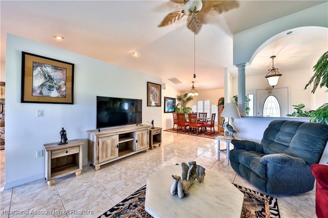 living room with arched walkways, ceiling fan, vaulted ceiling, and decorative columns