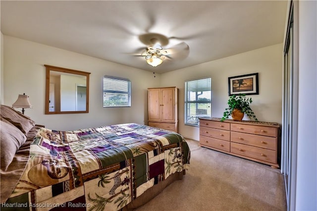 bedroom with light carpet and ceiling fan