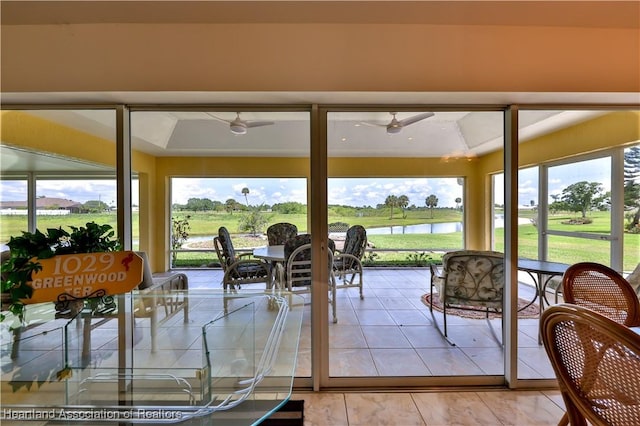 sunroom / solarium featuring a water view
