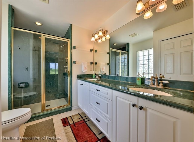 bathroom with tile patterned floors, visible vents, toilet, and a sink