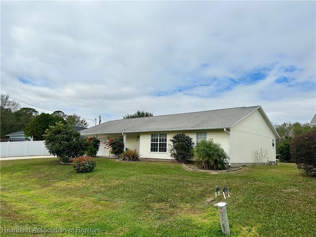 ranch-style home featuring a front yard