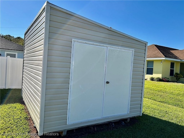 view of outdoor structure with a lawn