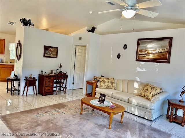 living room with light tile patterned flooring, ceiling fan, and vaulted ceiling