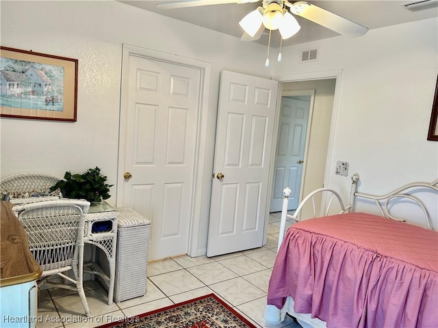 tiled bedroom featuring ceiling fan