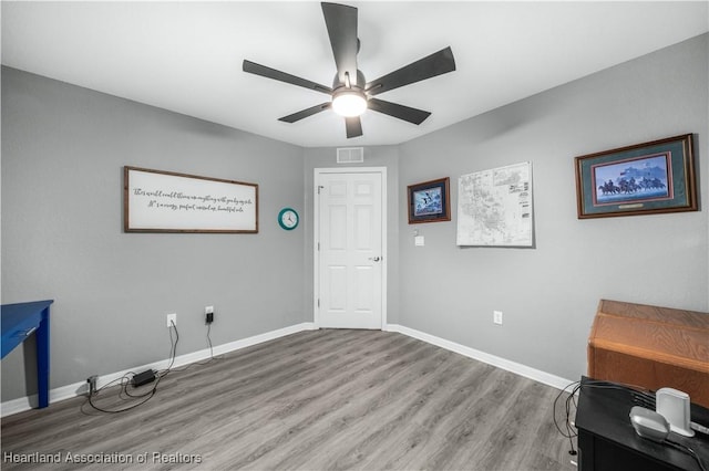 interior space with hardwood / wood-style flooring and ceiling fan