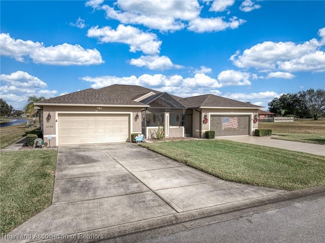 view of front of property featuring a garage and a front lawn