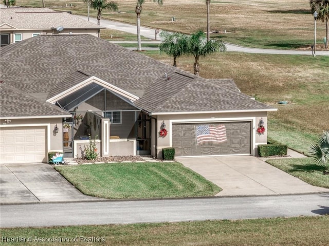 view of front of house with a front yard and a garage