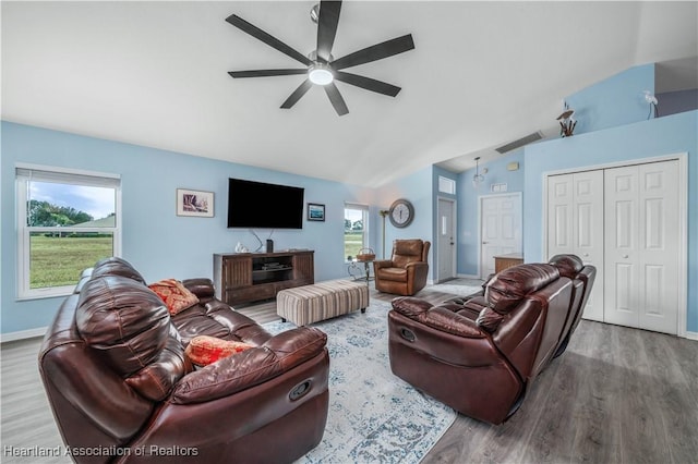 living room with ceiling fan, wood-type flooring, and vaulted ceiling