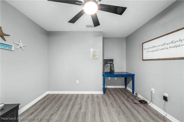 interior space with light wood-type flooring and ceiling fan