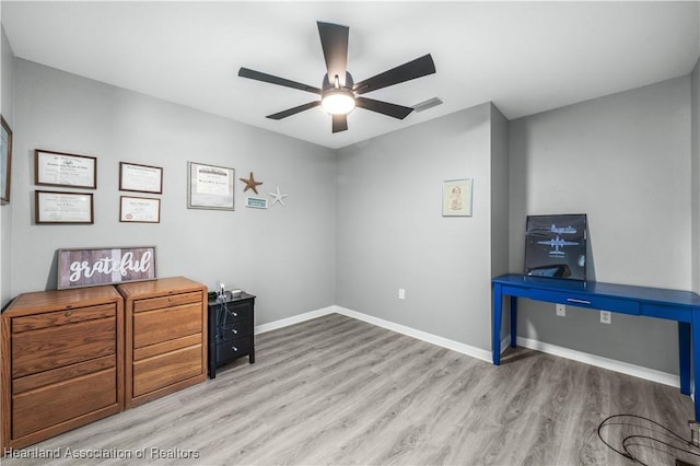 office with ceiling fan and light hardwood / wood-style flooring