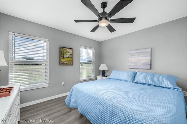 bedroom with ceiling fan and hardwood / wood-style flooring