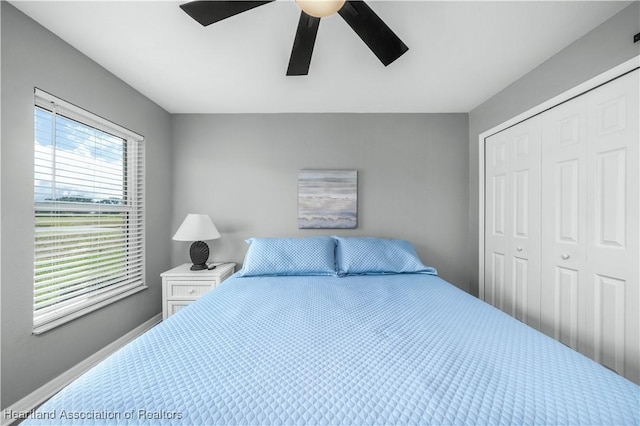 bedroom with ceiling fan and a closet