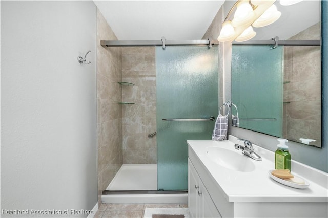 bathroom featuring tile patterned floors, vanity, and an enclosed shower