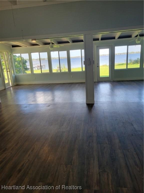 empty room featuring ceiling fan and dark hardwood / wood-style floors