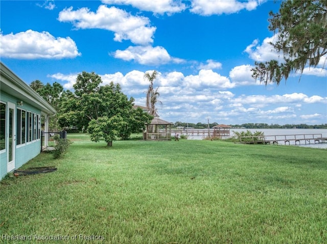 view of yard with a gazebo and a water view