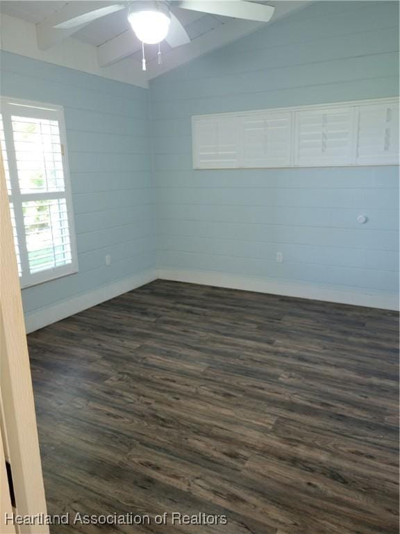 unfurnished room featuring lofted ceiling with beams, ceiling fan, and dark wood-type flooring