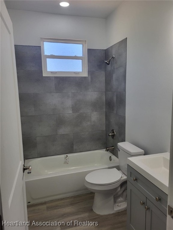 full bathroom featuring shower / bathtub combination, vanity, toilet, and wood finished floors