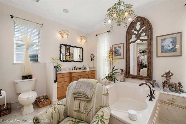 bathroom with a washtub, vanity, crown molding, and a healthy amount of sunlight