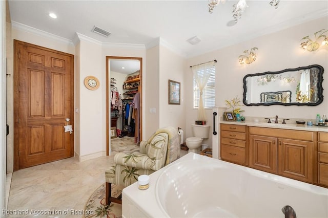 bathroom with crown molding, vanity, and a bath