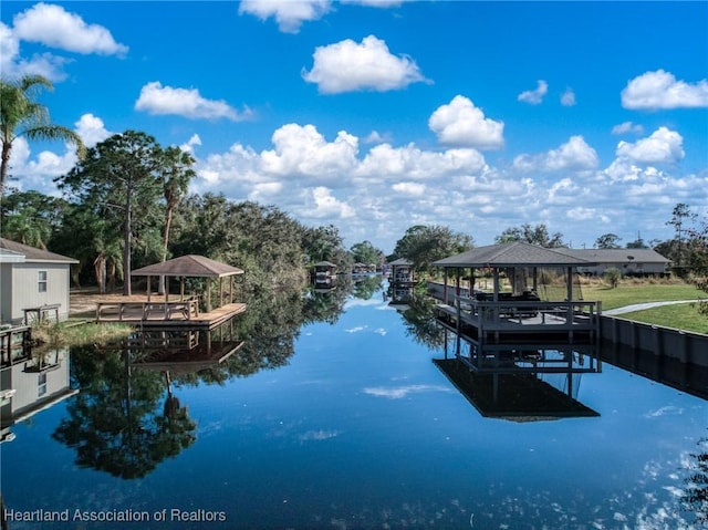 view of dock with a gazebo and a water view