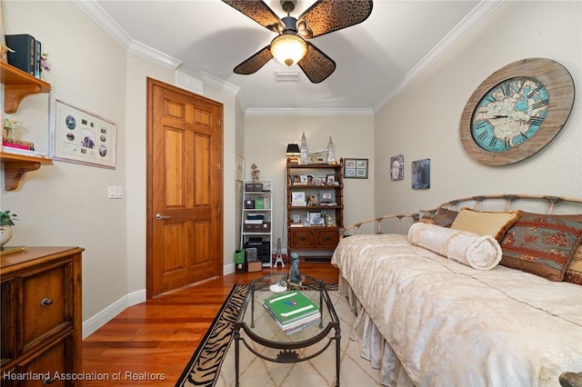 bedroom featuring ornamental molding, wood-type flooring, and ceiling fan