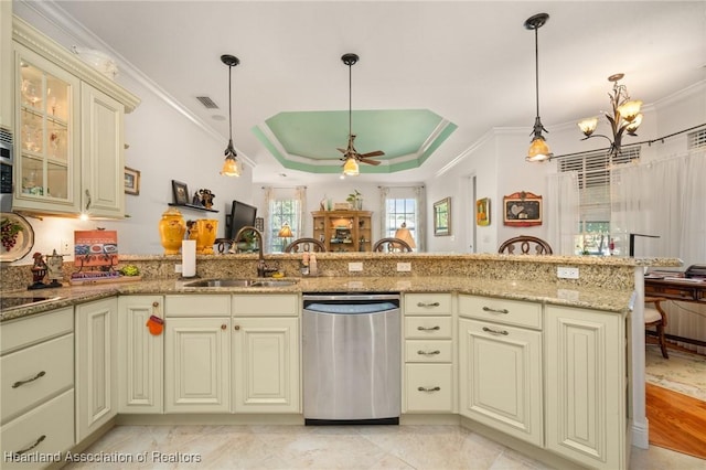 kitchen featuring pendant lighting, dishwasher, sink, kitchen peninsula, and cream cabinets