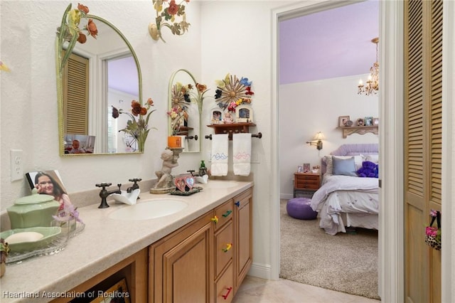 bathroom featuring an inviting chandelier and vanity