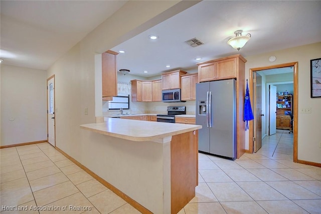 2211 Pinewood Blvd, Sebring, FL 33870 - kitchen featuring visible vents, light tile patterned floors, light countertops, a peninsula, and stainless steel appliances