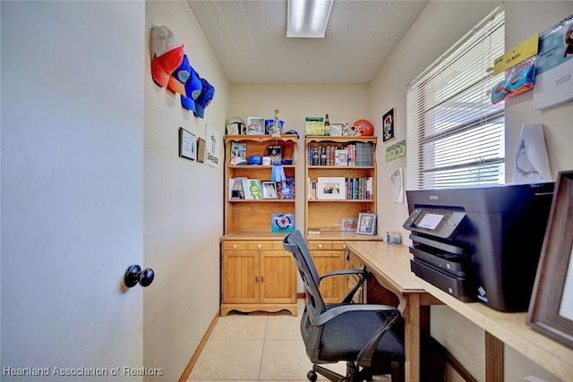 2211 Pinewood Blvd, Sebring, FL 33870 - office area featuring built in desk, a textured ceiling, baseboards, and light tile patterned flooring