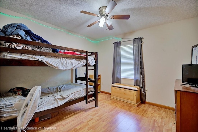 2211 Pinewood Blvd, Sebring, FL 33870 - bedroom with a textured ceiling, light wood-type flooring, baseboards, and ceiling fan