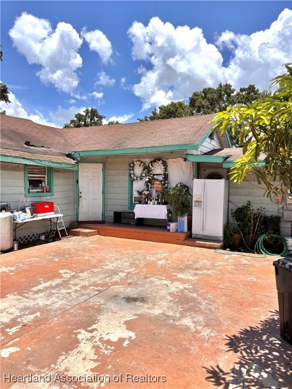 205 E Townsend St, Wauchula, FL 33873 - view of front facade featuring concrete driveway, a garage, and a porch