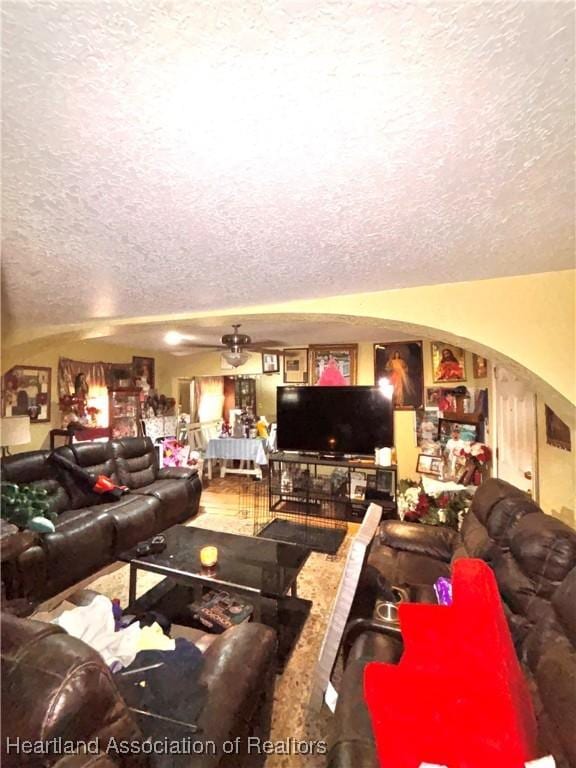 205 E Townsend St, Wauchula, FL 33873 - living area with a textured ceiling, arched walkways, and ceiling fan
