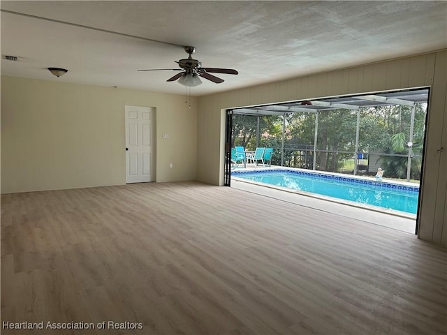 view of swimming pool featuring ceiling fan