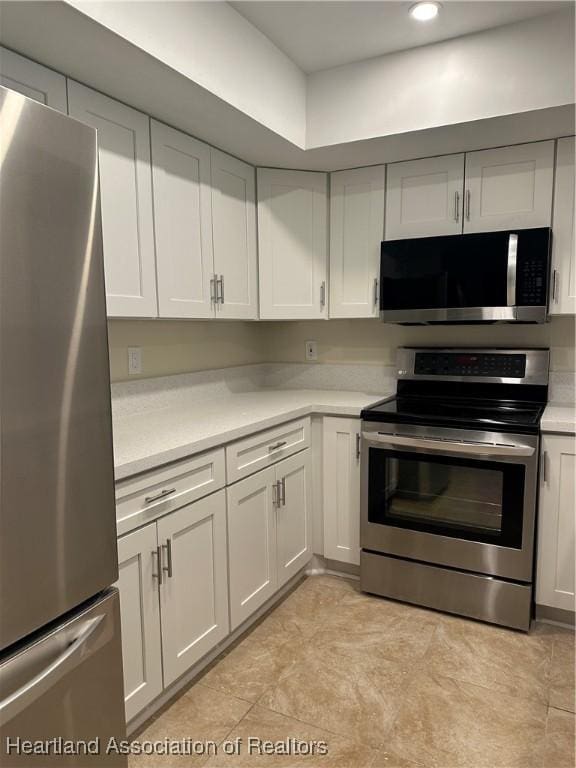 kitchen with white cabinetry and stainless steel appliances