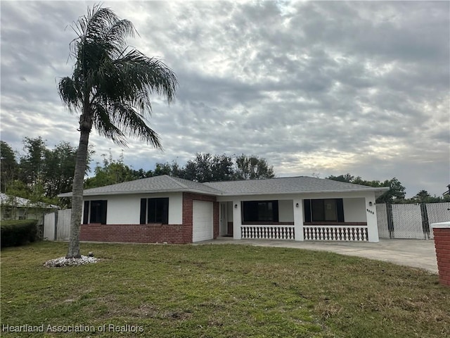 ranch-style home with a garage and a front yard