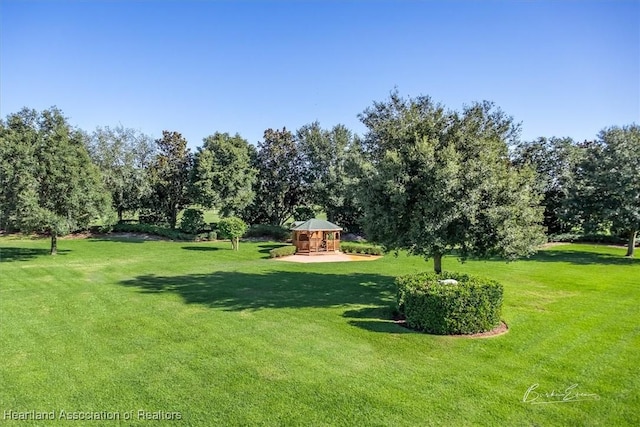 5220 Haw Rd, Sebring, FL 33875 - view of green lawn featuring a gazebo and view of wooded area