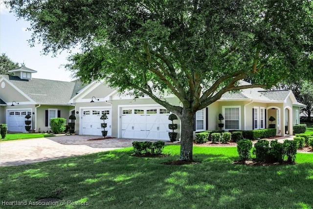 5220 Haw Rd, Sebring, FL 33875 - view of front facade featuring decorative driveway, a garage, and a front lawn