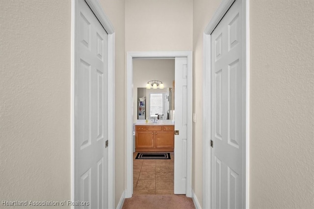 5220 Haw Rd, Sebring, FL 33875 - hallway featuring light tile patterned floors, a textured wall, and light colored carpet
