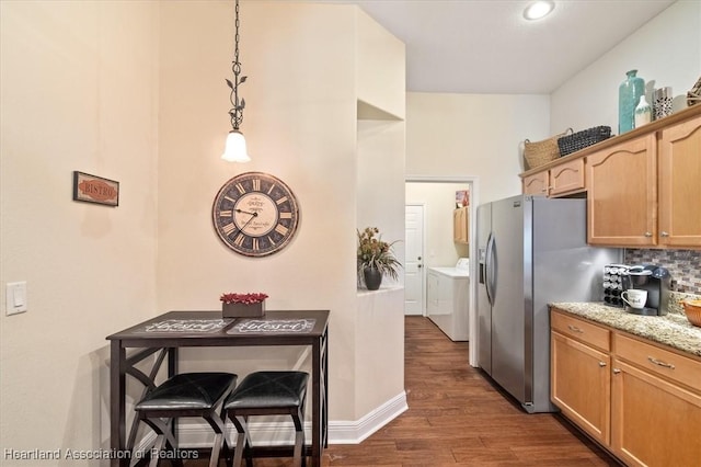 5220 Haw Rd, Sebring, FL 33875 - kitchen with washing machine and clothes dryer, stainless steel fridge with ice dispenser, dark wood-type flooring, backsplash, and pendant lighting