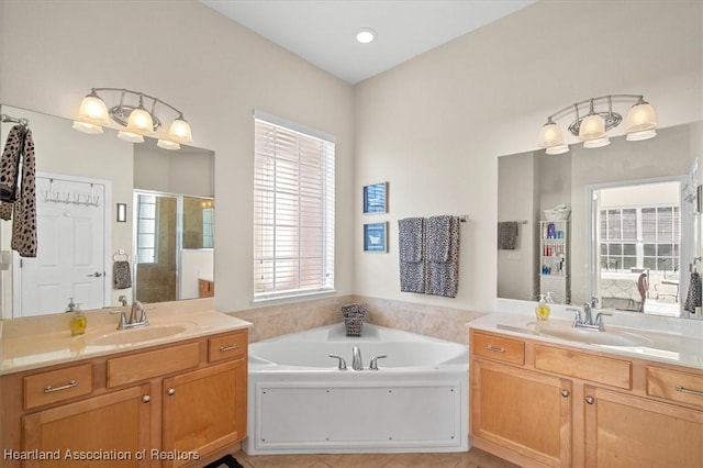 5220 Haw Rd, Sebring, FL 33875 - bathroom with two vanities, a bath, a shower stall, and healthy amount of natural light