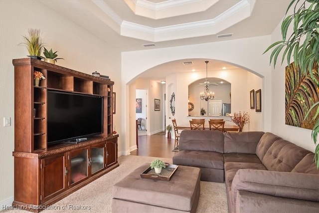 5220 Haw Rd, Sebring, FL 33875 - living area featuring arched walkways, crown molding, a chandelier, and a tray ceiling