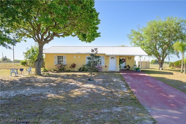 2443 W Newton Rd, Avon Park, FL 33825 - view of front of property featuring stucco siding, an attached carport, and driveway
