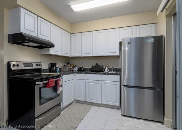 2443 W Newton Rd, Avon Park, FL 33825 - kitchen featuring dark countertops, under cabinet range hood, white cabinets, stainless steel appliances, and a sink
