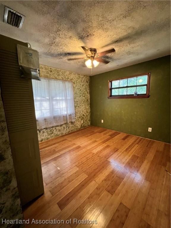 1801 Colmar Ave, Sebring, FL 33870 - unfurnished room featuring hardwood / wood-style floors, a textured ceiling, and ceiling fan