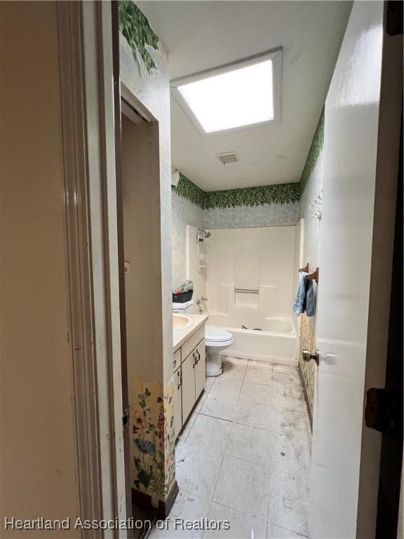 1801 Colmar Ave, Sebring, FL 33870 - full bathroom featuring tile patterned floors, vanity,  shower combination, and toilet