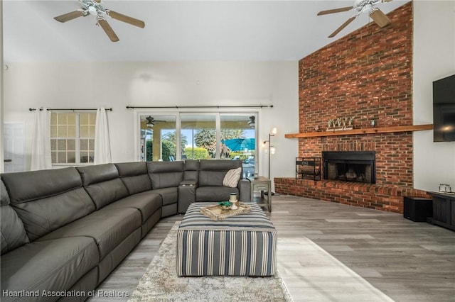 living room featuring light hardwood / wood-style floors and a brick fireplace