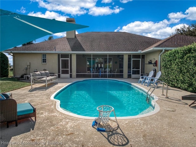 view of swimming pool featuring a patio and a sunroom