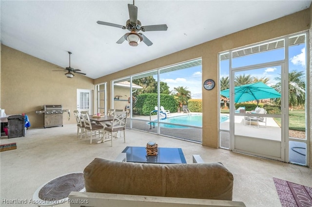 interior space with vaulted ceiling, ceiling fan, and plenty of natural light