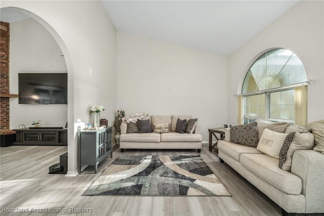 living room featuring light hardwood / wood-style floors and lofted ceiling