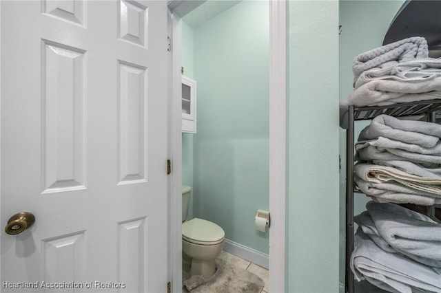 bathroom with tile patterned floors and toilet